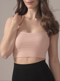 Woman wearing a light pink seamless bralette