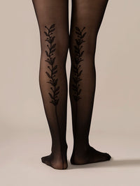 Back view close-up of the legs in the Back Vine Sheer Tights in Black, showing the vine pattern running up the back.